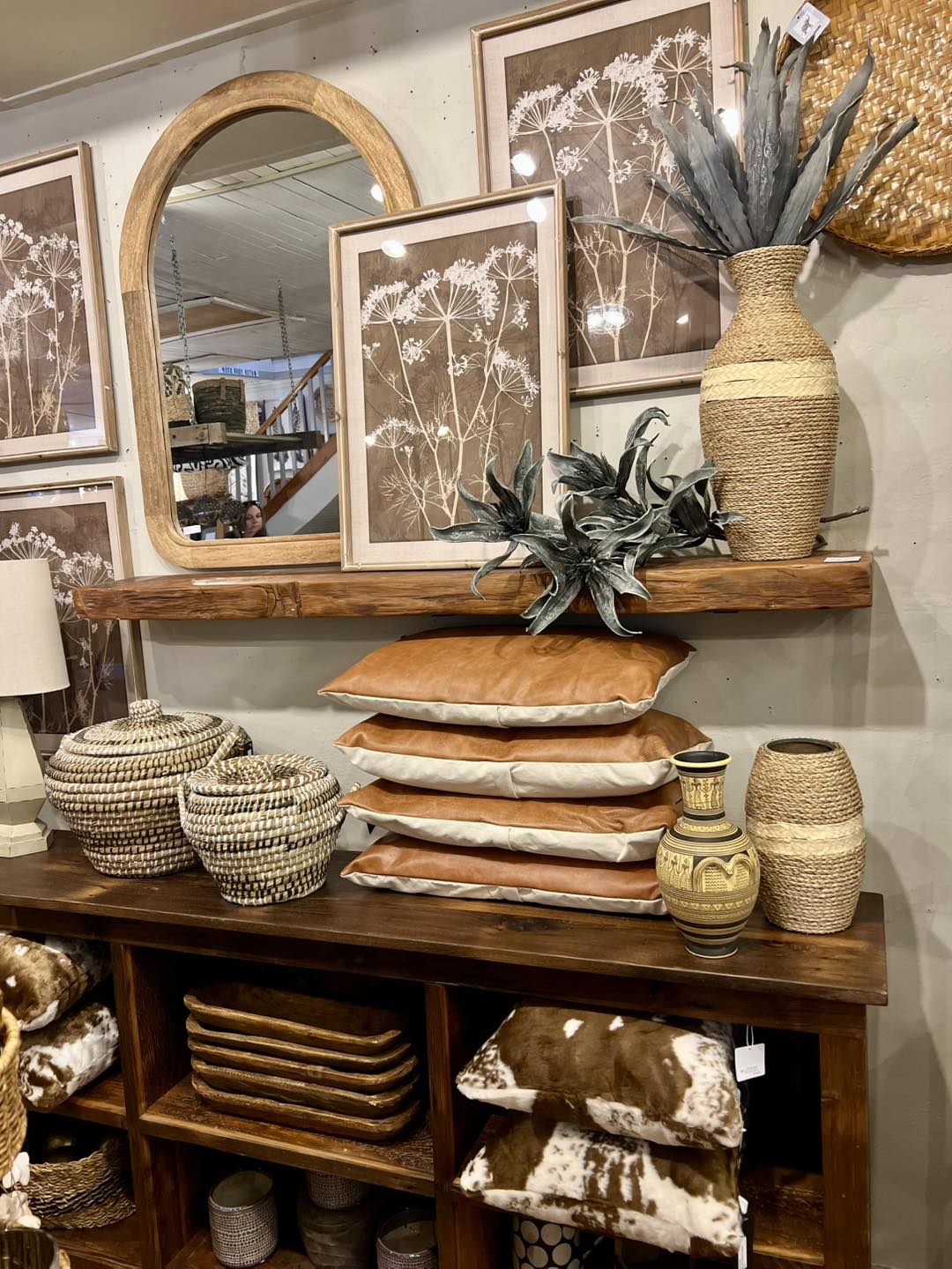 retail market with pillows, bookcase, botanical art, and baskets